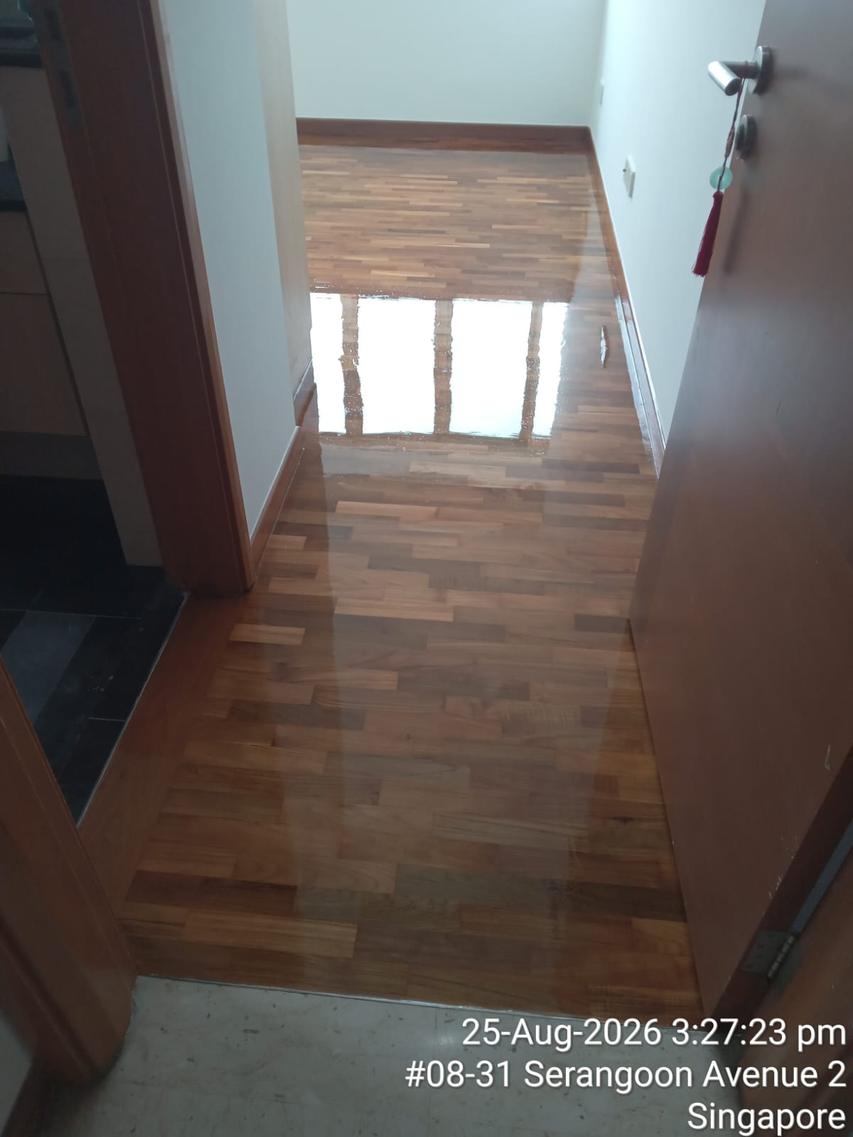 A freshly polished parquet corridor floor showing a glossy finished result